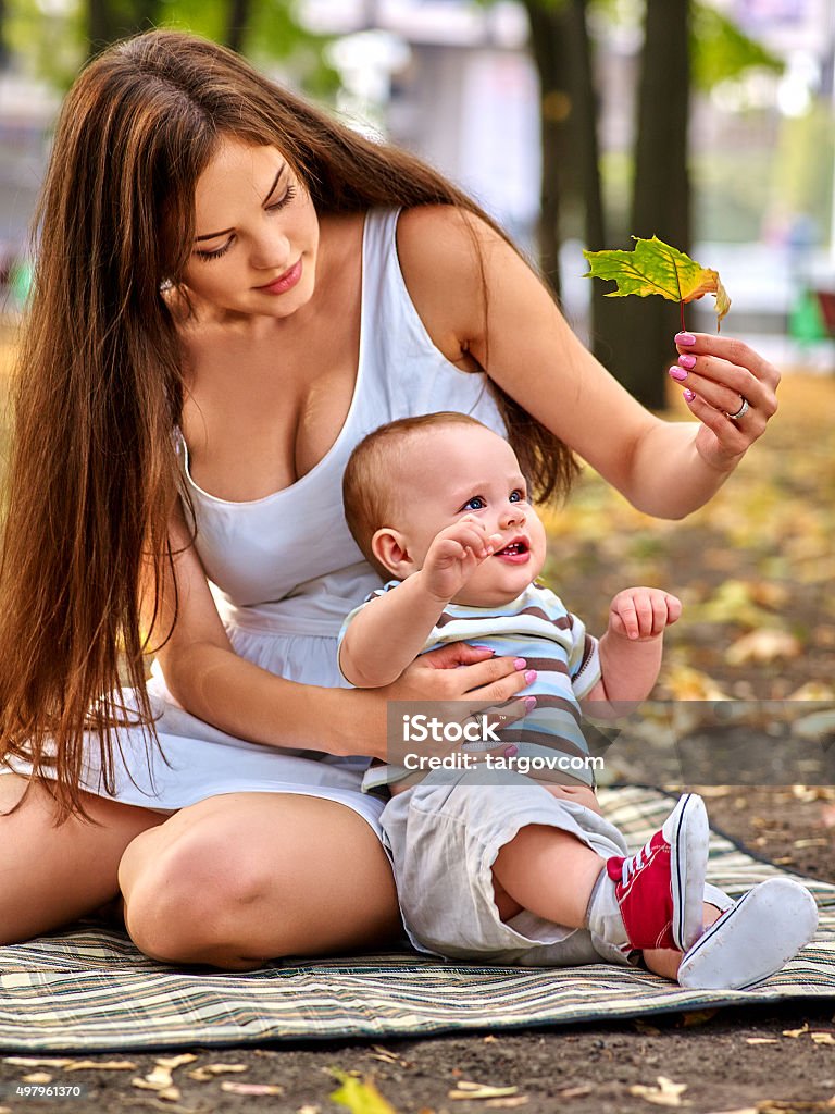 Happy loving mother and her baby outdoors  Mother and her baby go walk  in park outdoors. 12-17 Months Stock Photo