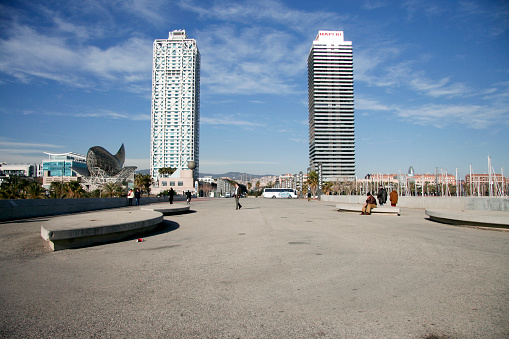 Barcelona, Spain - December 31, 2007: Barceloneta Beach with Hotel Arts, Mapfre tower, several restaurants, the goldfish of Frank Gehry