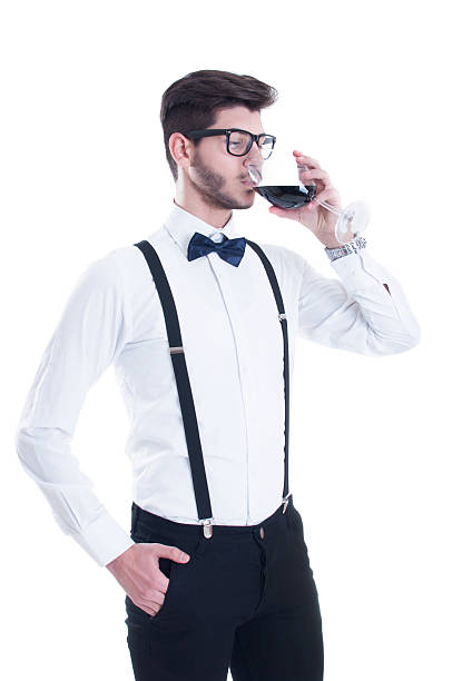 istock Young man tasting red wine. Isolated on white background 497964374