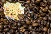 Map of Kenya under a background of coffee beans