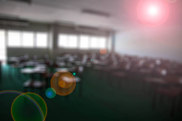 istock chairs in the big classroom blurred Lens flare background 497966434