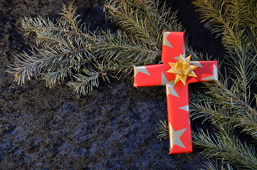 cross wrapped in paper as a present at Christmas day because Jesus was born to give his life for us.