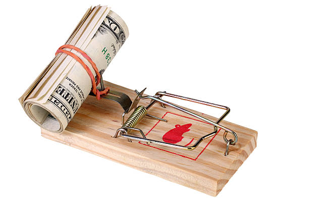 Photo of a mouse trap with money as bait, concept stock photo