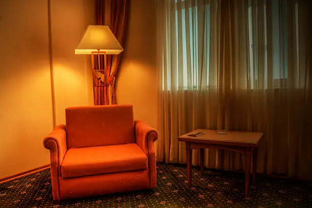 Beautiful room with red armchair and lamp