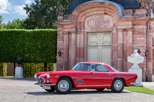 Schwetzingen, Germany - August 29, 2014: A legendary Maserati 3500 GT, red, sports, classic car in excellent condition at a vintage car meeting. This model was produced from 1957-1964.