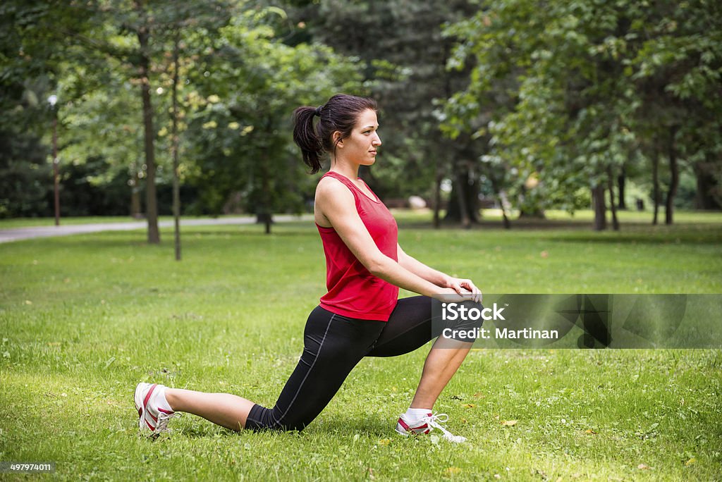 Warm up exercise - sport woman Young sport woman exercising before jogging - outside in nature Active Lifestyle Stock Photo