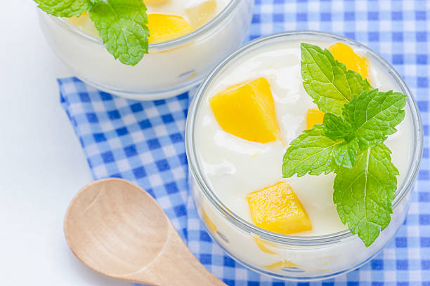 istock Yogurt with mango  in a glass jars on white background 497974057