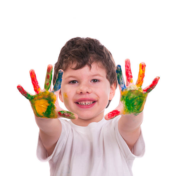 istock Boy with hands painted colorful paint 497974089