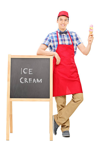 Ice cream vendor standing by a blackboard