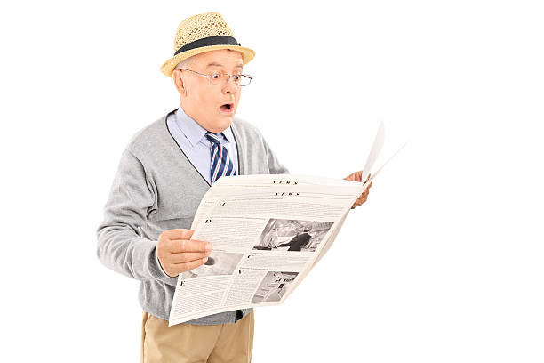 istock Surprised senior gentleman reading the news 497975603