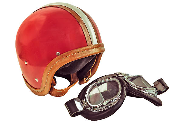 Retro styled image of an old motor helmet with goggles isolated on a white background