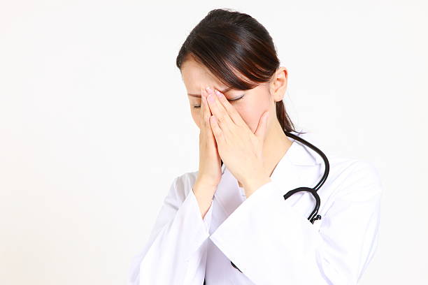 istock young Japanese female doctor suffers 497977399