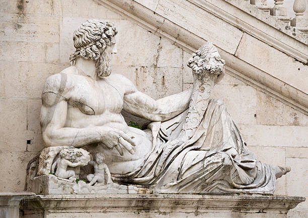 istock Statue, symbolizing the Tiber River. Senators Palace, Rome 497979405