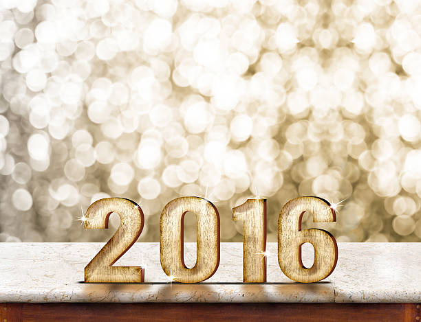 istock 2016 year wood texture on marble table with gold sparkling 497981814