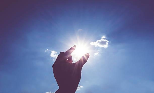 istock Silhouette of Hand picking sun at blue sky and cloud 497982302