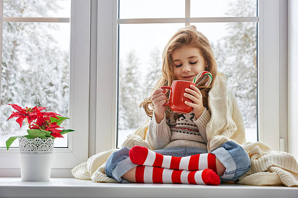 istock little girl sitting by the window 497983994