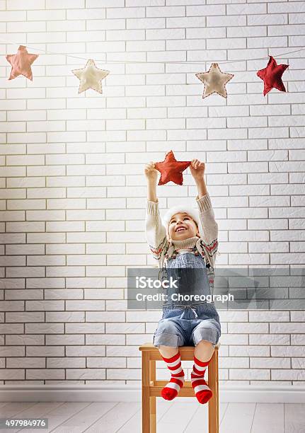 Child Hangs The Stars Stock Photo - Download Image Now - 2015, Baby - Human Age, Baby Clothing