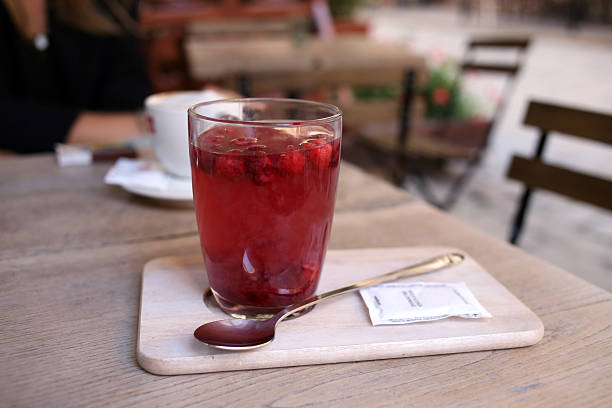 istock Glass of raspberry compote served the board with a spoon 497986464