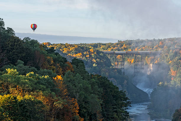 Sunrise From Inspiration Point At Letchworth State Park Sunrise From Inspiration Point At Letchworth State Park In New York With A Hot Air Balloon Flying Near The Railroad Trestle letchworth state park stock pictures, royalty-free photos & images