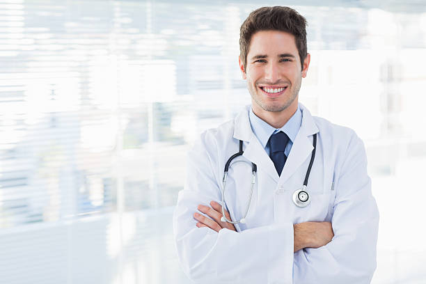 istock Smiling doctor crossed his arms and looking at camera 497992391
