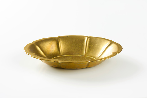Empty flower shaped golden metal bowl