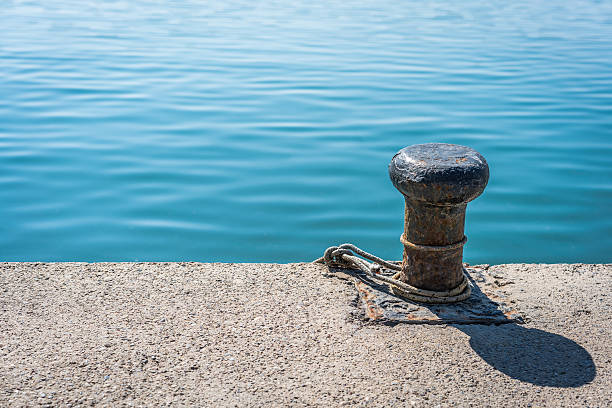 Bollard, rope and a sea.