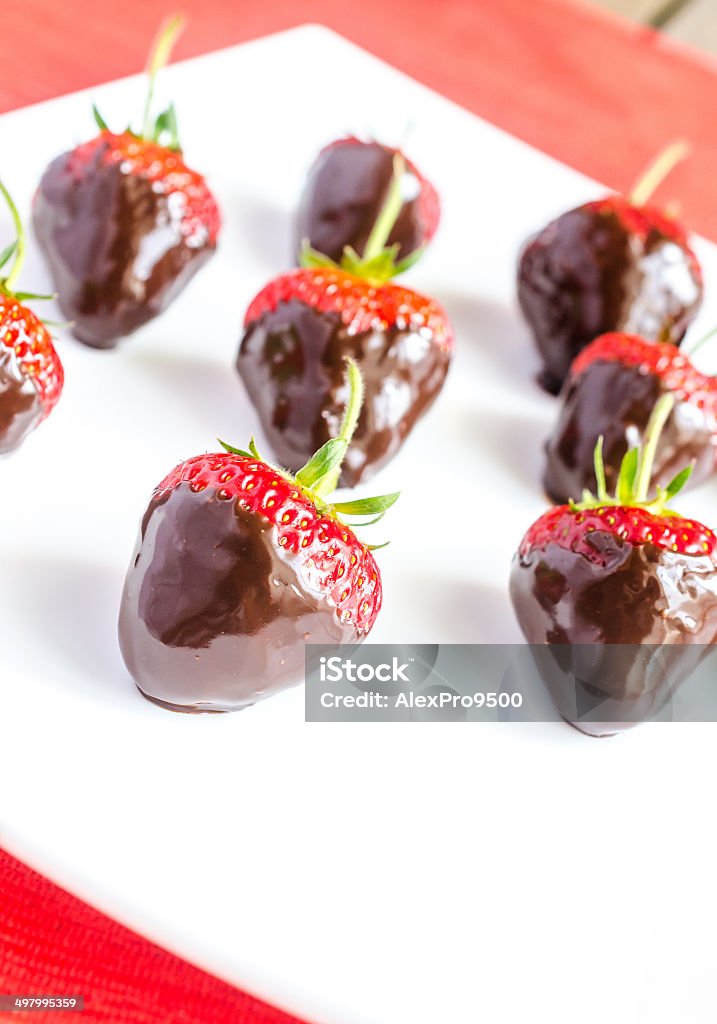 Fresh strawberries covered with dark chocolate Berry Fruit Stock Photo