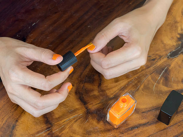 istock Manicure - Beautiful manicured woman's nails with orange nail po 497996840