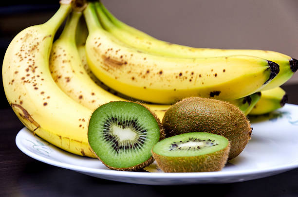 Kiwis and bananas stock photo