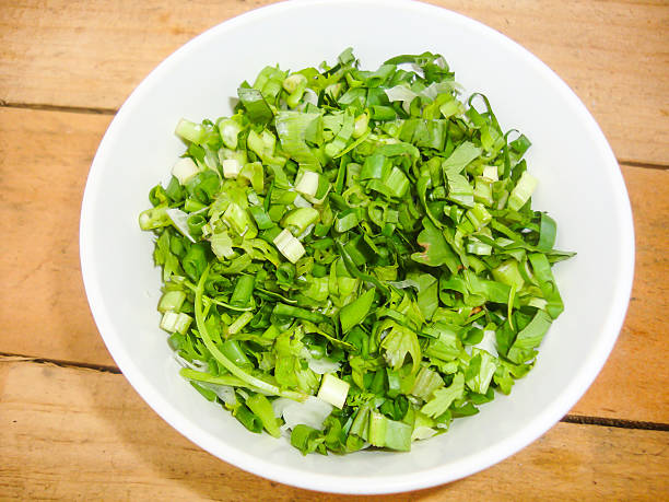 istock chopped green onions in small cup on wooden background 497999687