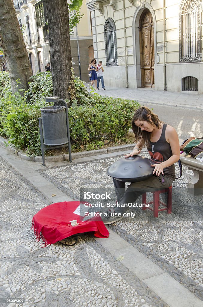 Girl playing Hang Granada,Spain - May 18, 2014:  Beautiful street musician playing an instrument called Hang. Andalusia Stock Photo