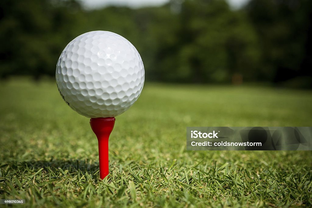 Tee Off Golf ball on red tee. Golf Ball Stock Photo