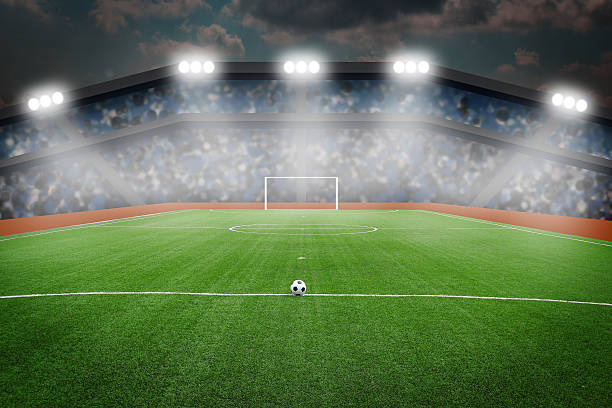 istock Soccer ball on field in stadium at night 498010597