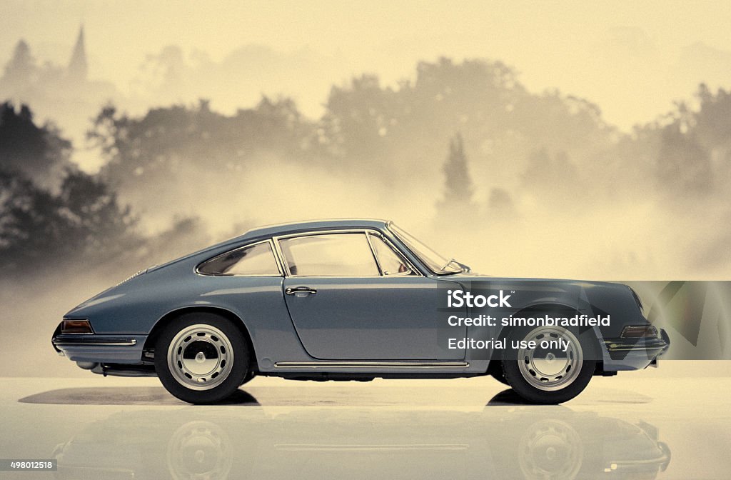 Classic Porsche 911 Model Beaconsfield, UK - October 2, 2015: A 1:18 scale model of a 1964 Porsche 911 made by Auto Art, set against a background of trees in the mist. Post processed in a Tin Type style. Porsche Stock Photo