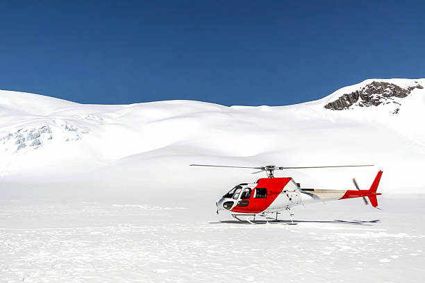istock Red & White Helicopter landed on a Mountain in Snow 498012806