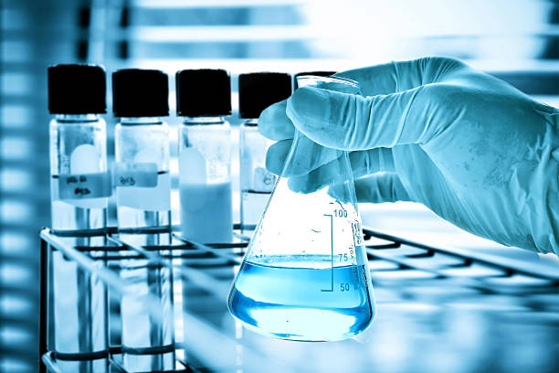istock Flask and test tubes in scientist hand 498012810