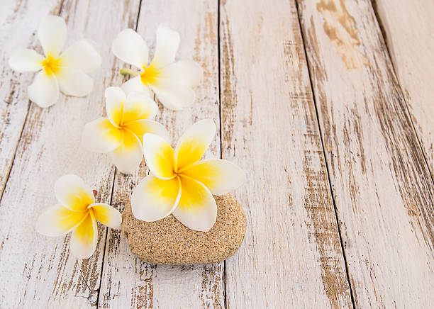 istock Tropical Plumeria and stone therapy on wooden table 498013890