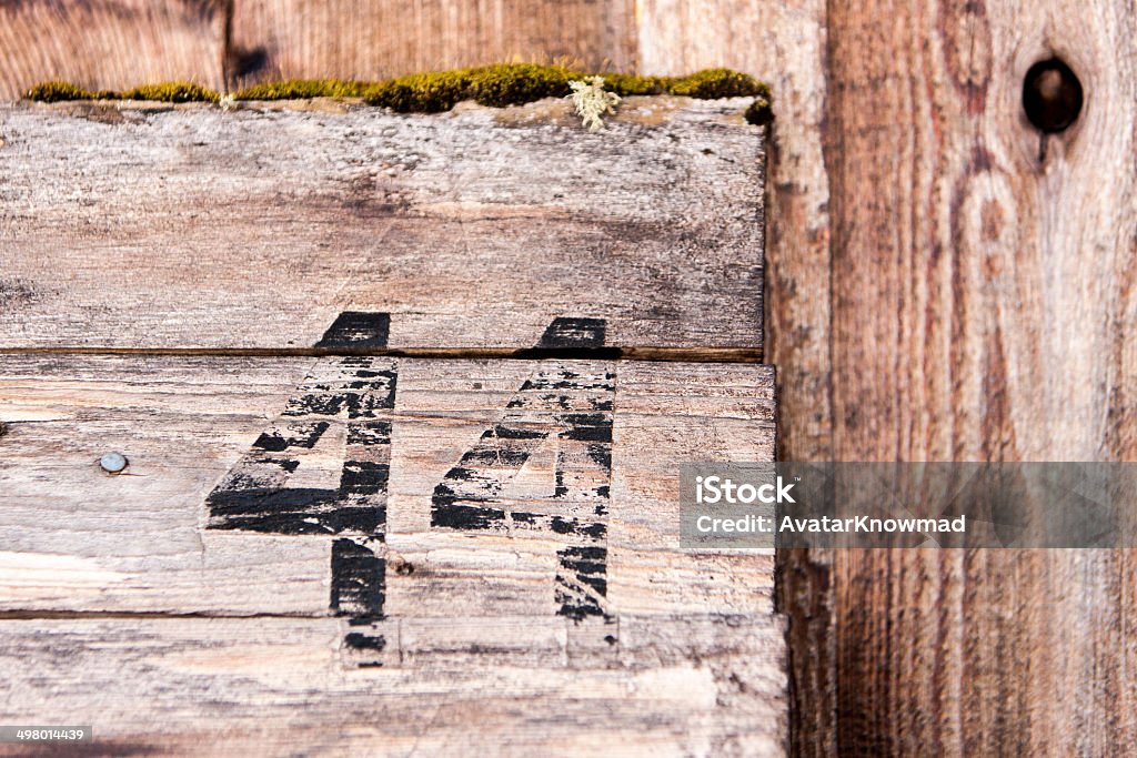 Number 44 on Wood A close up of the number 44 spray painted on a wooden surface. Horizontal image shows the texture of a wooden structure. The number 44 is painted in black and is worn. 40-44 Years Stock Photo