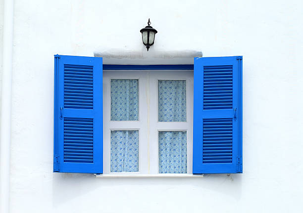 istock Blue wooden Window on the white concrete wall 498014543