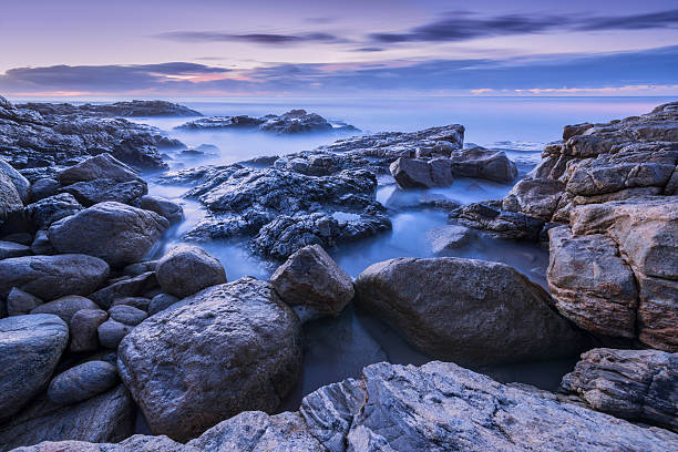 istock Misty waves crashing on the rocks 498014783
