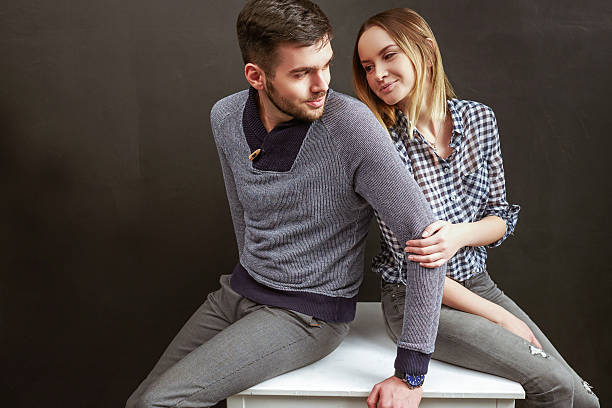 istock Young man and woman sitting indoors 498014816