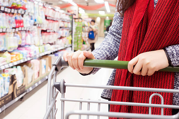 istock young woman pulling a shopping cart in a mall 498015530