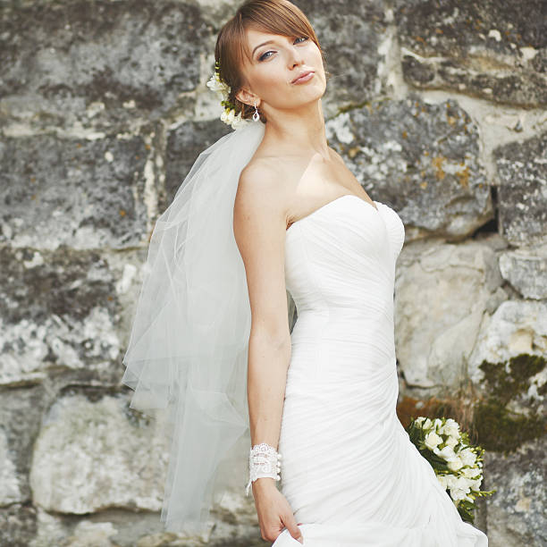 istock Gorgeous young bride enjoying wedding day. Summertime newlywed. 498016613