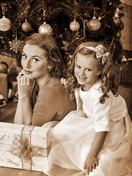 istock Kid with mother near Christmas tree 498017058