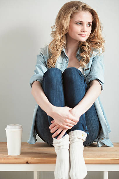 istock Young woman sitting on bench 498017496