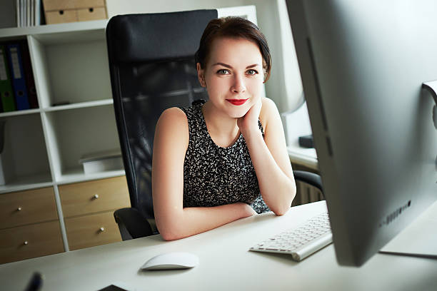 istock beautiful girl working at the computer in the office 498018558