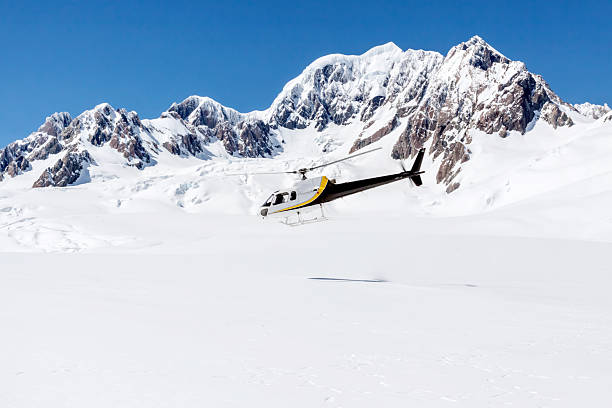 istock Helicopter Taking Off from a Snow Covered Mountain 498020092