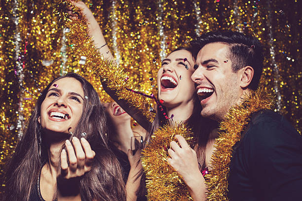 Party and confetti Happy people enjoing the party with confetti   Glamour  New Year  Party stock pictures, royalty-free photos & images