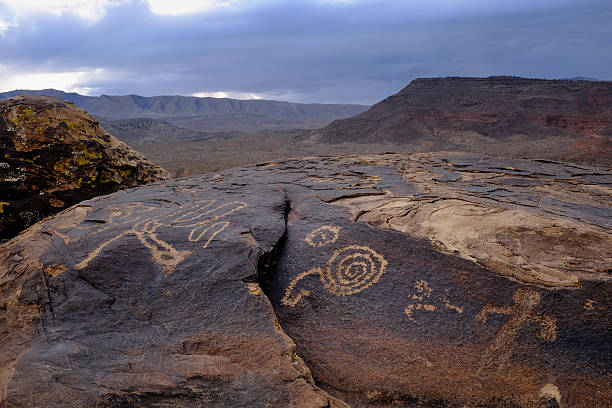 istock anasazi petroglyphs in front of desert mountains 498021780