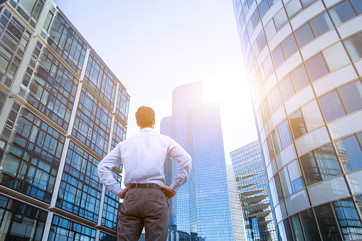 career concept, business background, man looking at office buildings